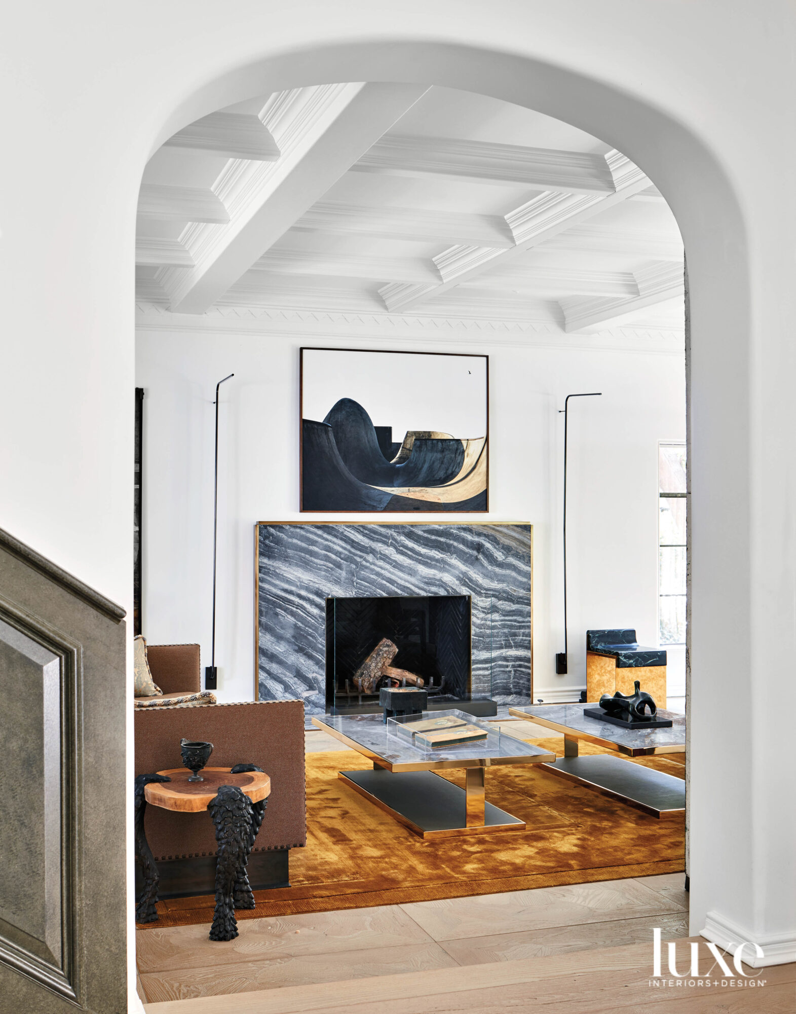View through doorway into living room looking at fireplace and artwork above