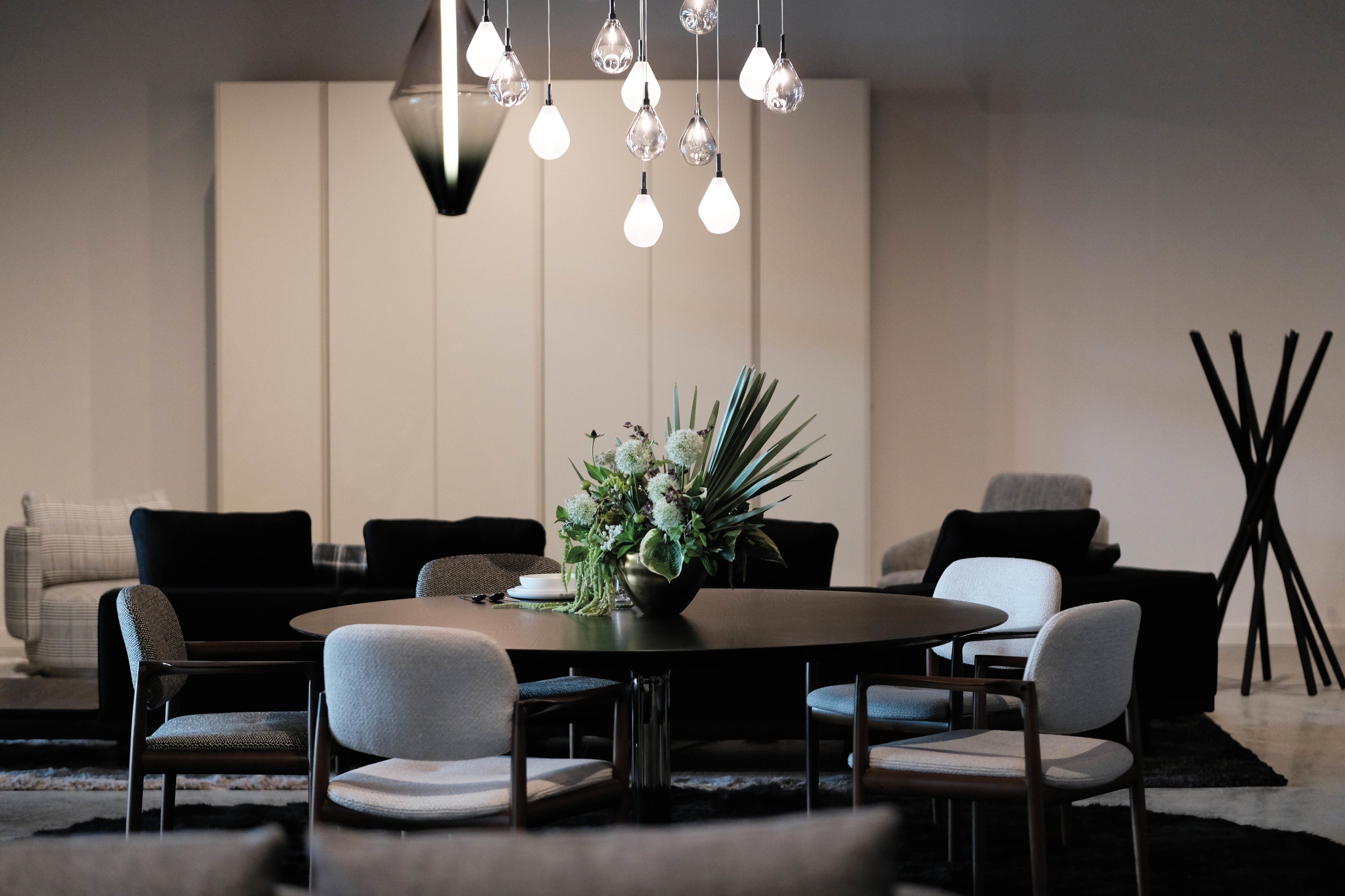 moody and dark living room area with pendant lights hanging above