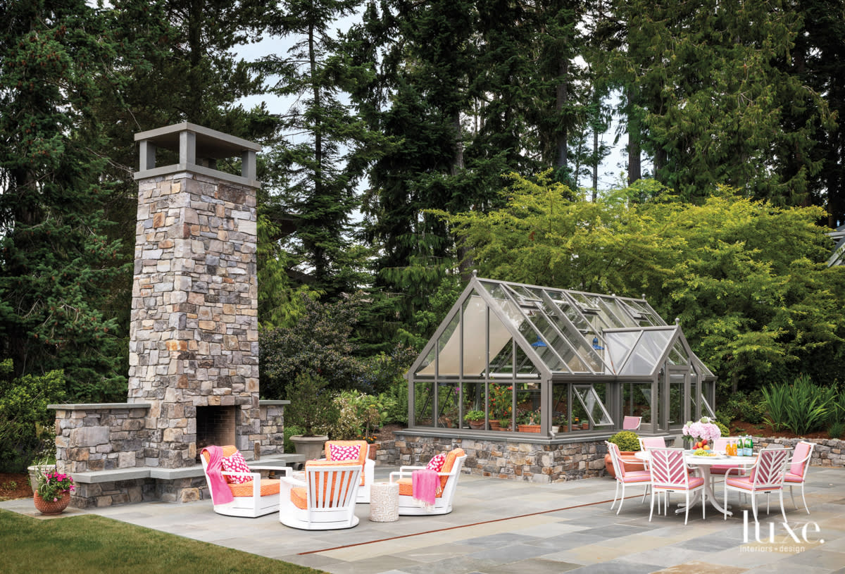 Greenhouse with a dining terrace and fireplace seating area nearby