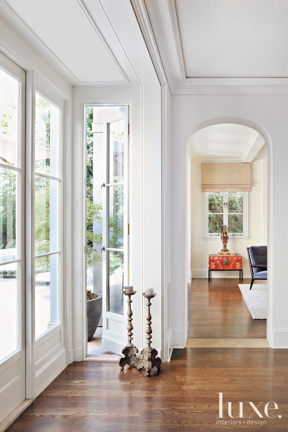 Mediterranean Neutral Hall with Arched Doorways | Luxe Interiors + Design