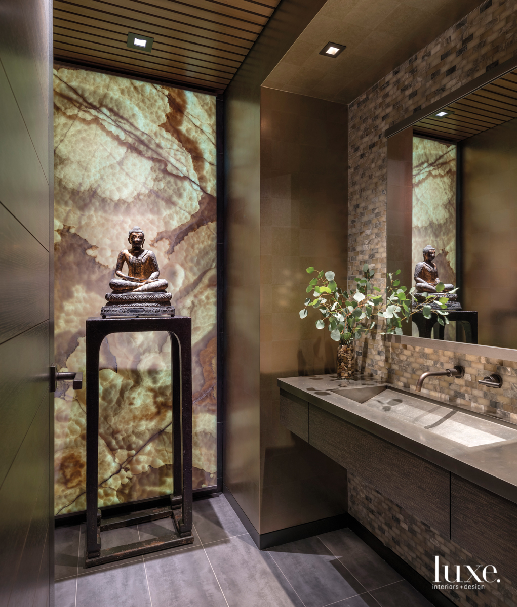 wellness room with dark walls and a Buddha state on a table