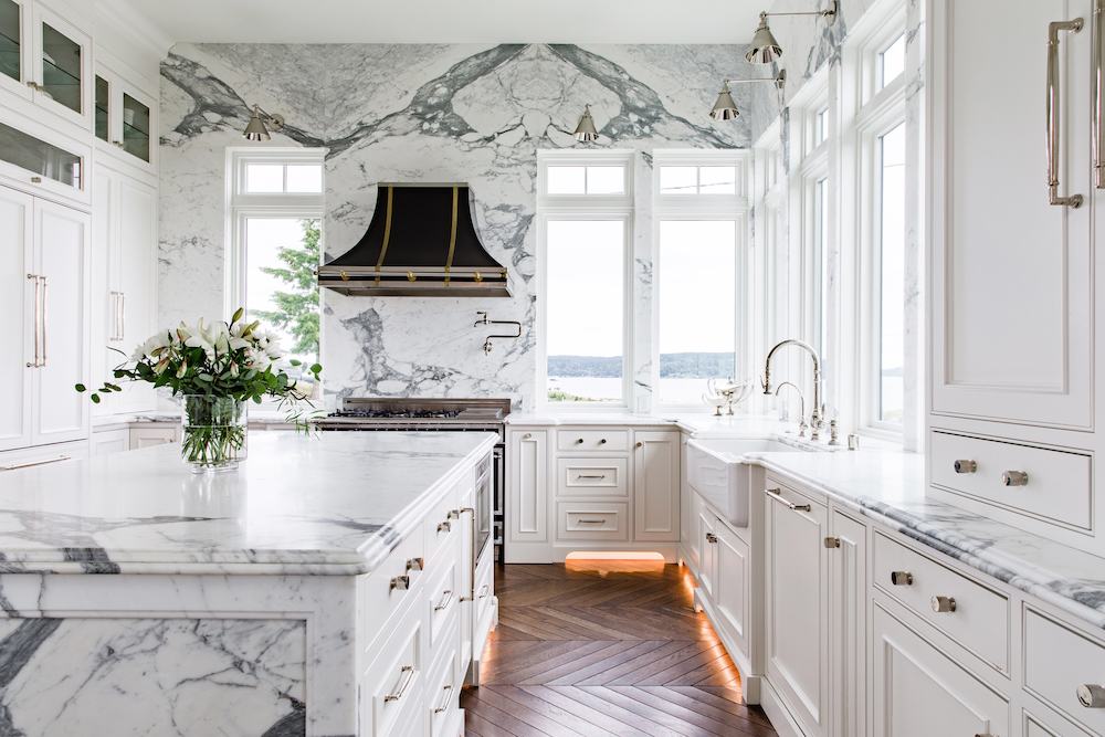 A modern kitchen featuring elegant marble countertops and a stylish marble island, showcasing a sophisticated design.