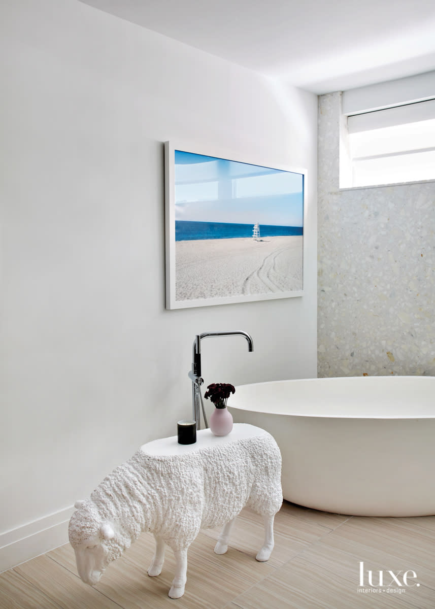master bathroom with a stand alone tub and a sheep to hold the soap