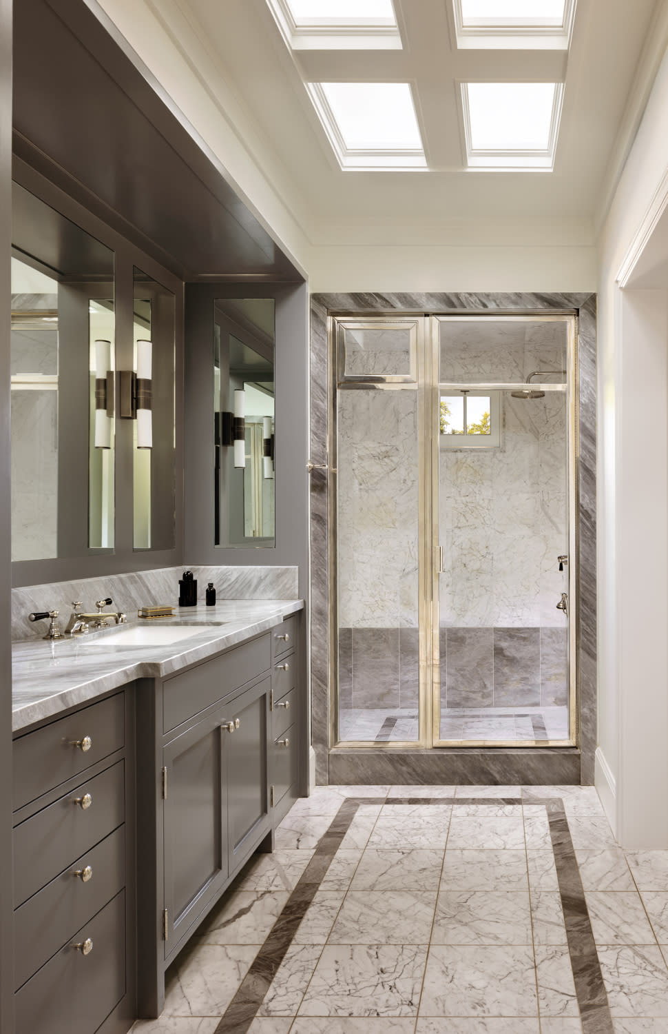 A bright bathroom featuring a skylight and a modern shower, creating an airy and open atmosphere.