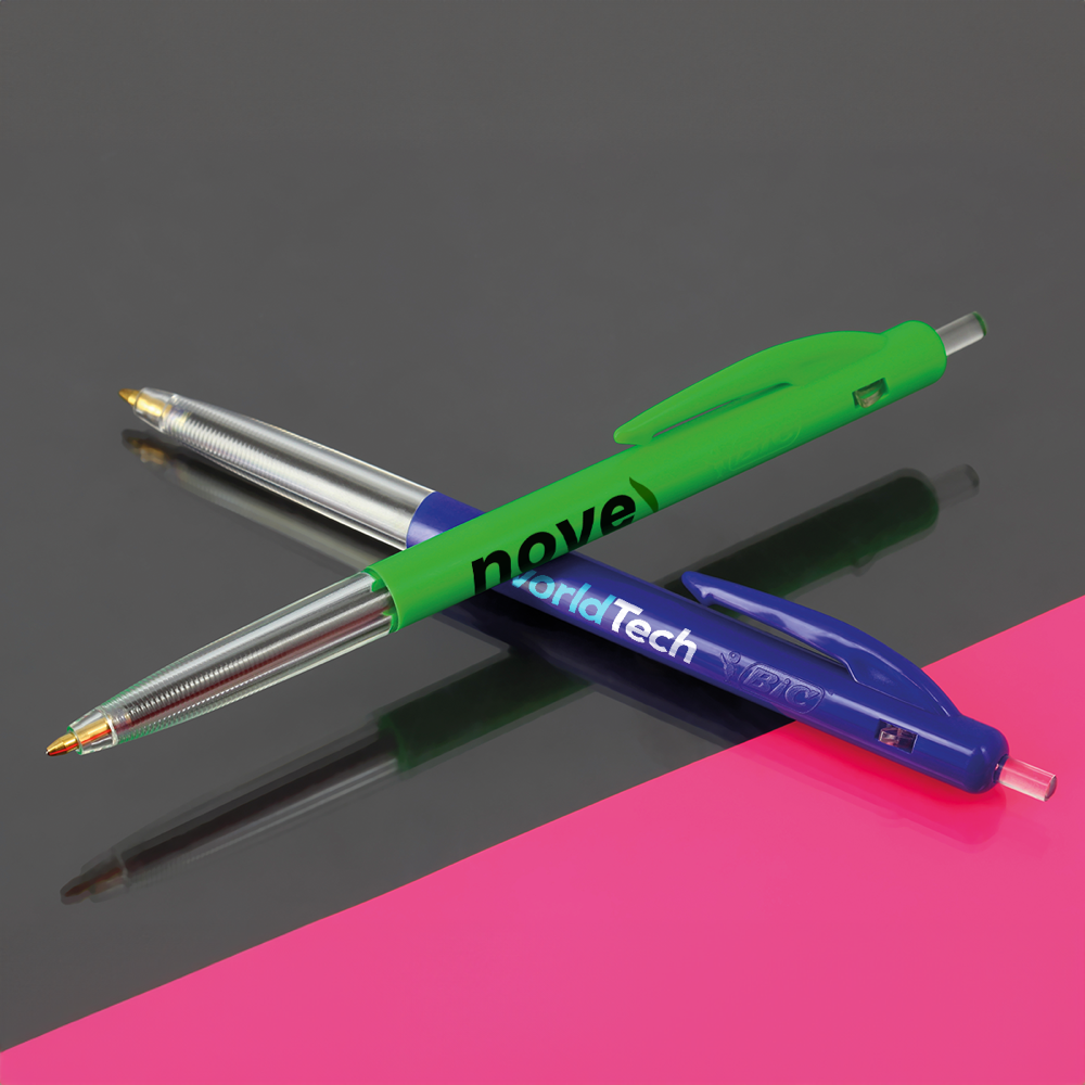 Two BIC M10 Clic ballpoint pens in green and dark blue with sample brand prints