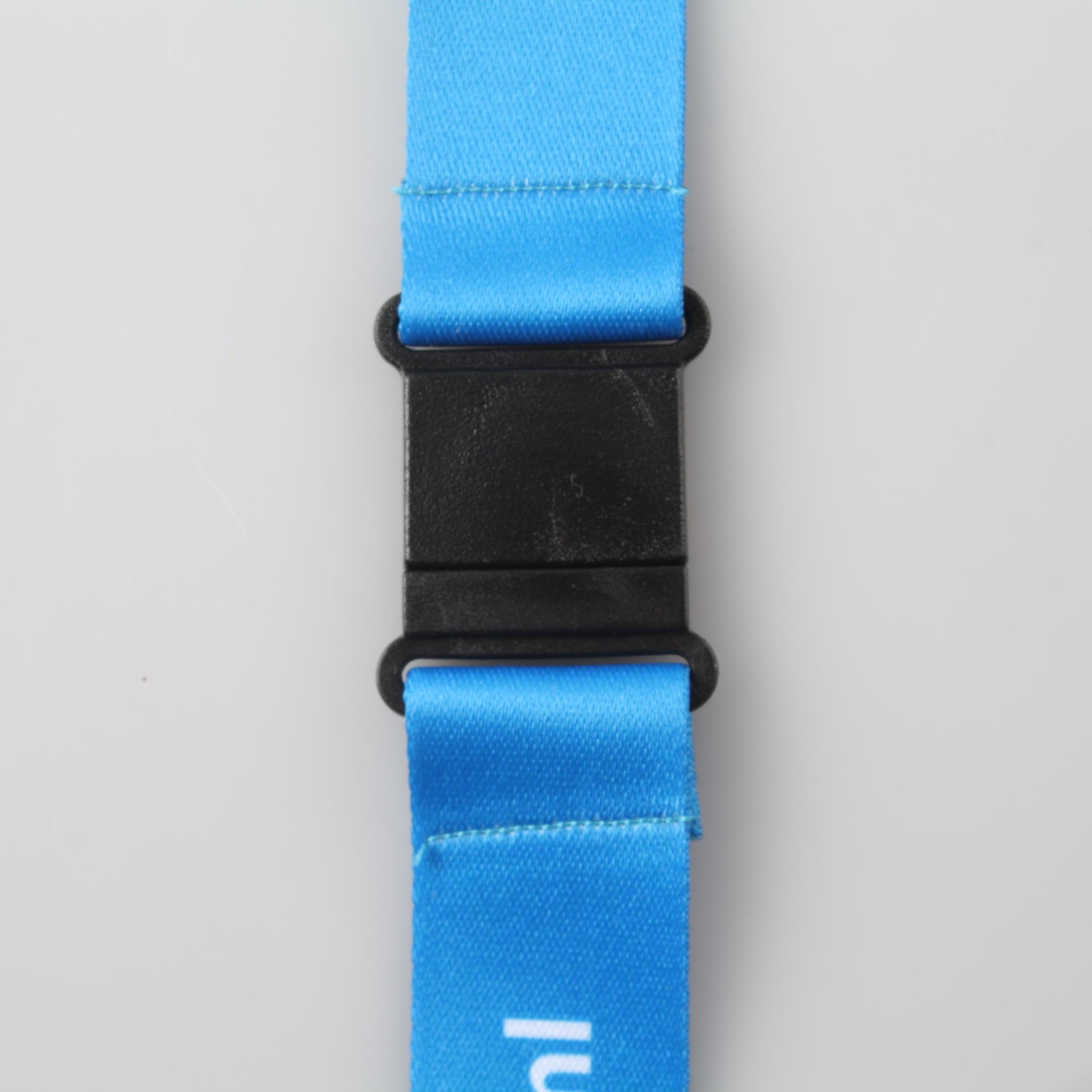 Close-up of the black safety breakaway clip on a blue lanyard strap