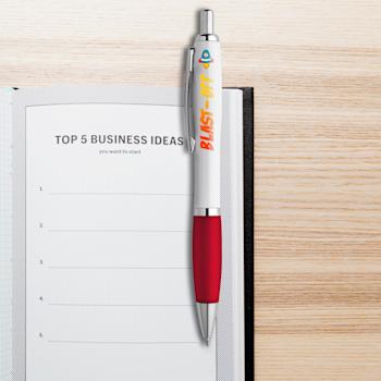 Stylo Nash deluxe blanc avec logo multicolore et grip rouge posé sur un carnet ouvert Top 5 Business Ideas