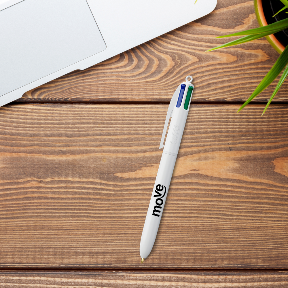 White BIC 4 Colours ballpoint pen with move print on a wooden desk