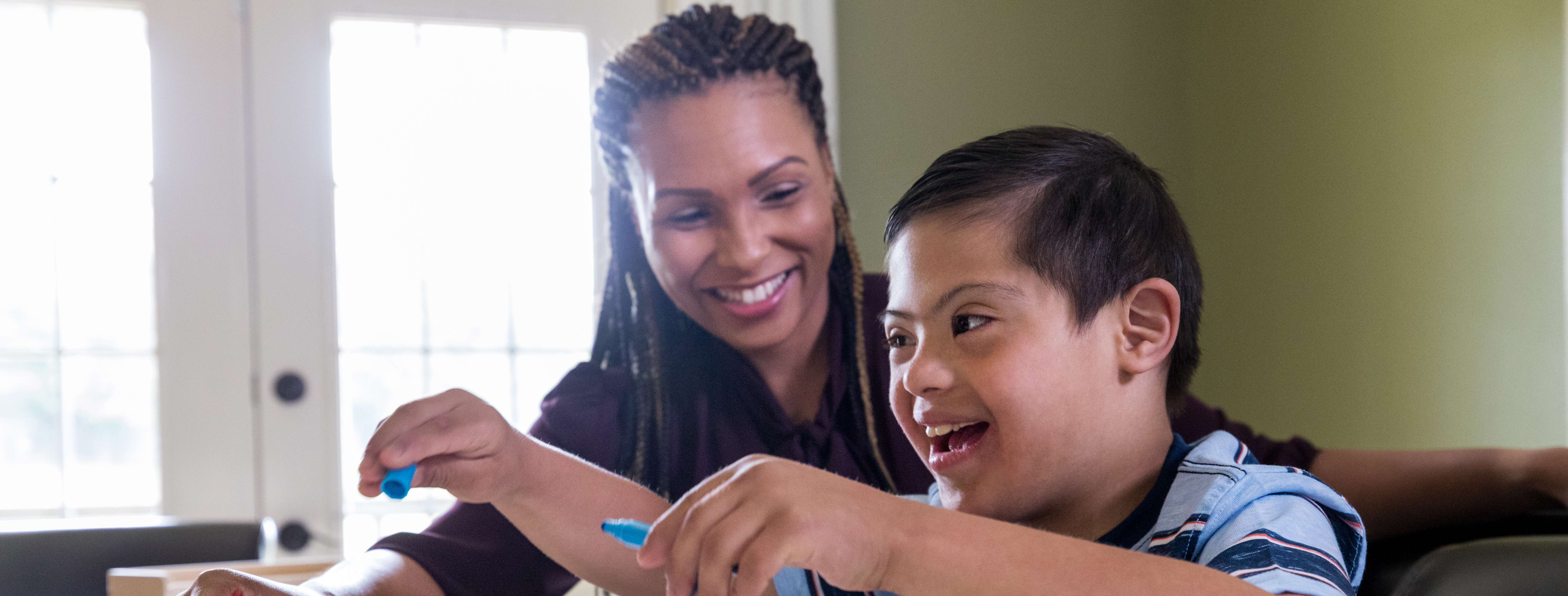 Licensed babysitter helping a child with an art project.