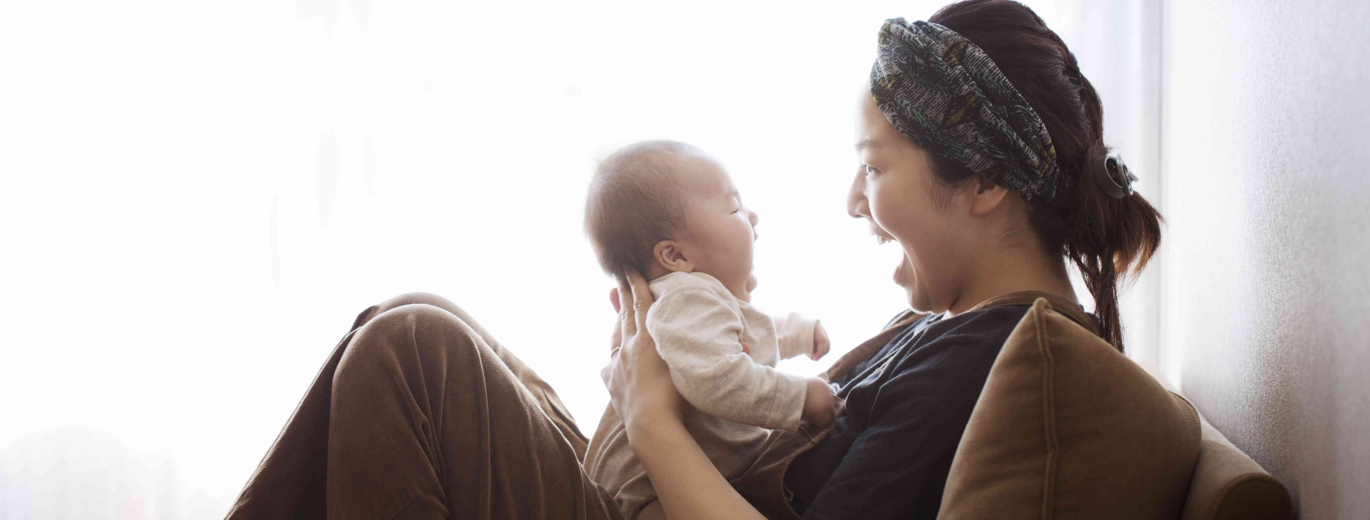 Child care provider holding a crying baby.