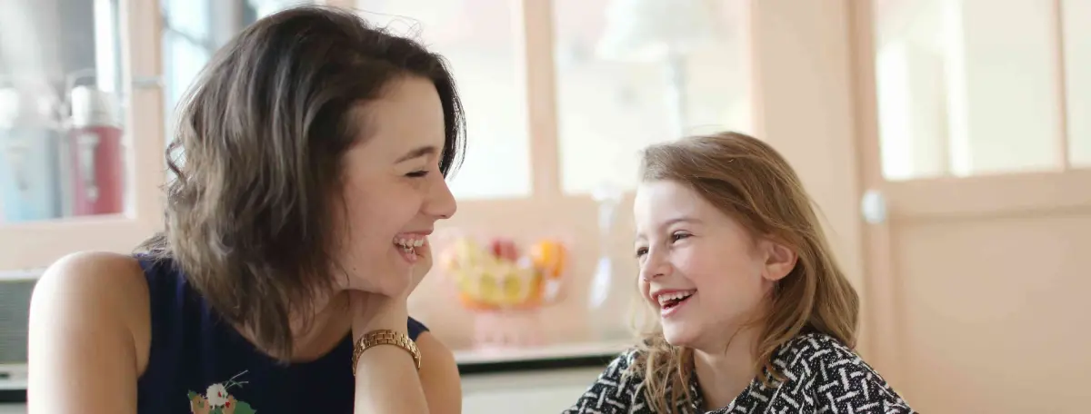 Italian-speaking babysitter laughing with a child