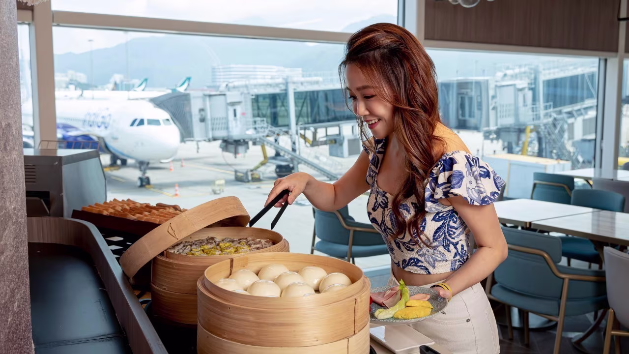 Woman dishing up food at buffet at airport lounge
