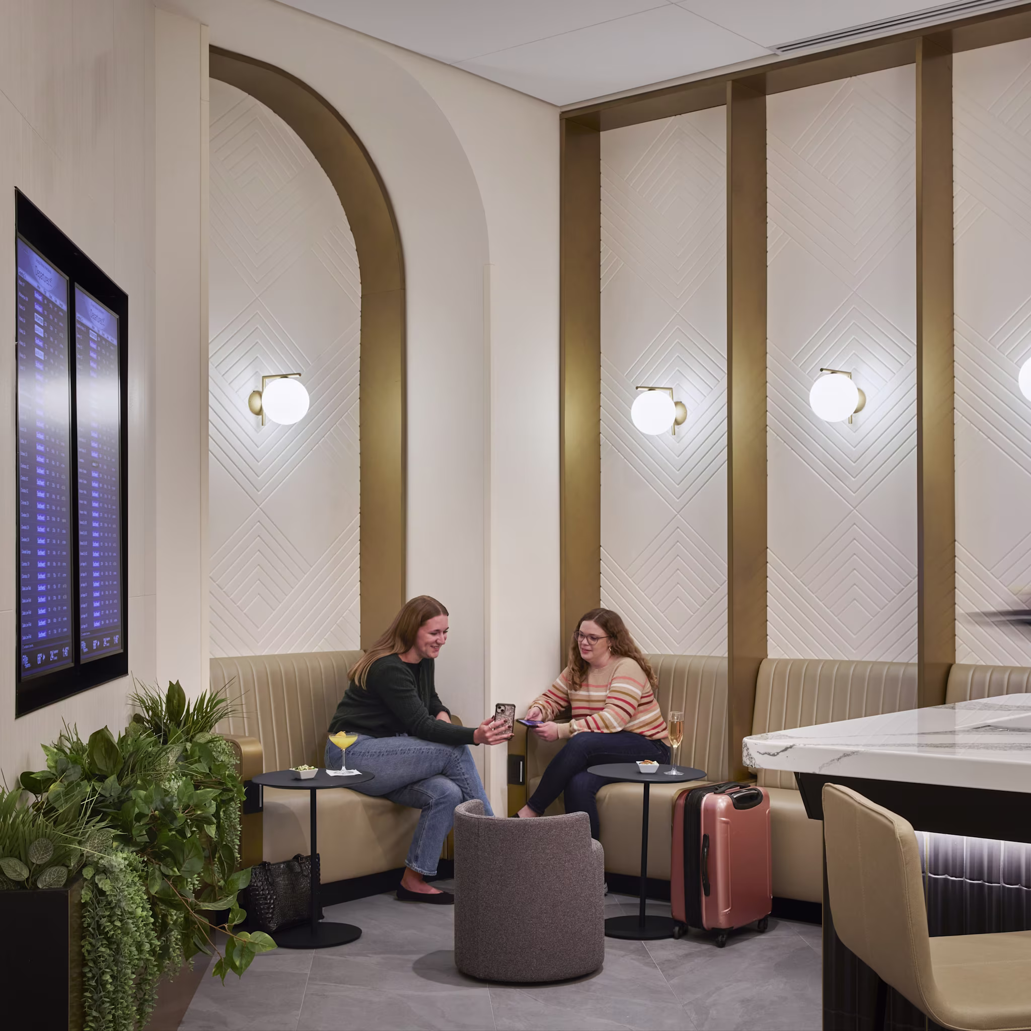 Two women sitting in airport lounge
