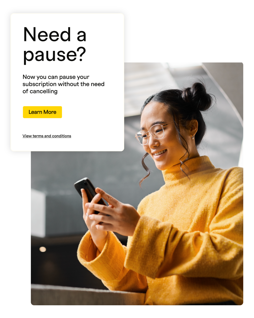 A woman in a yellow sweater smiles while using her phone, with a prompt about pausing a subscription in the background.