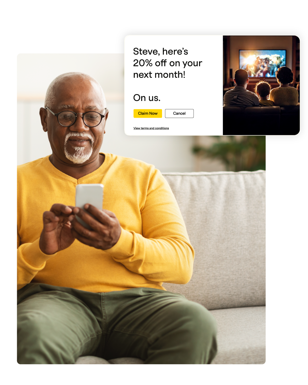 An older man in a yellow sweater smiles at his phone, with a TV showing a family watching in the background.