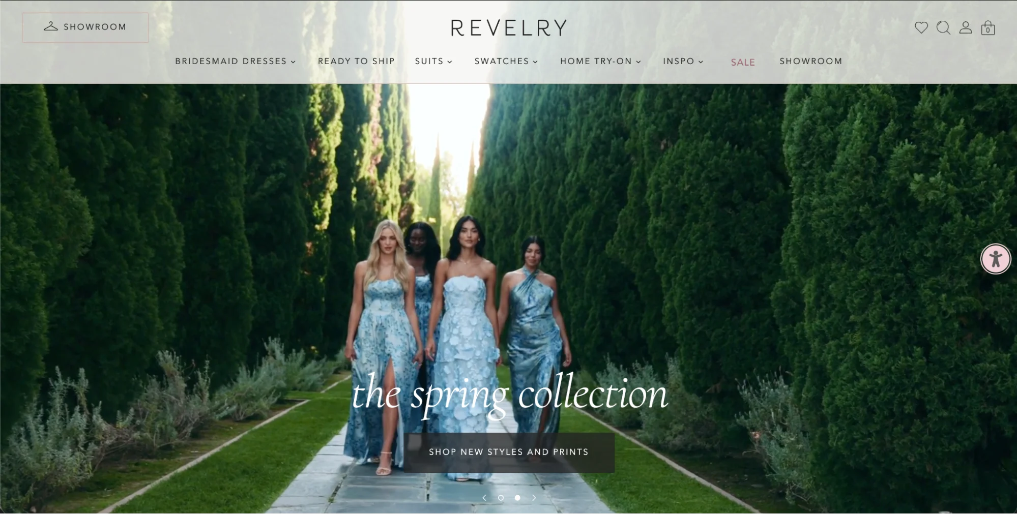 Revelry spring bridesmaid dresses in mismatched blue shades and floral prints standing in a lush cypress tree path.