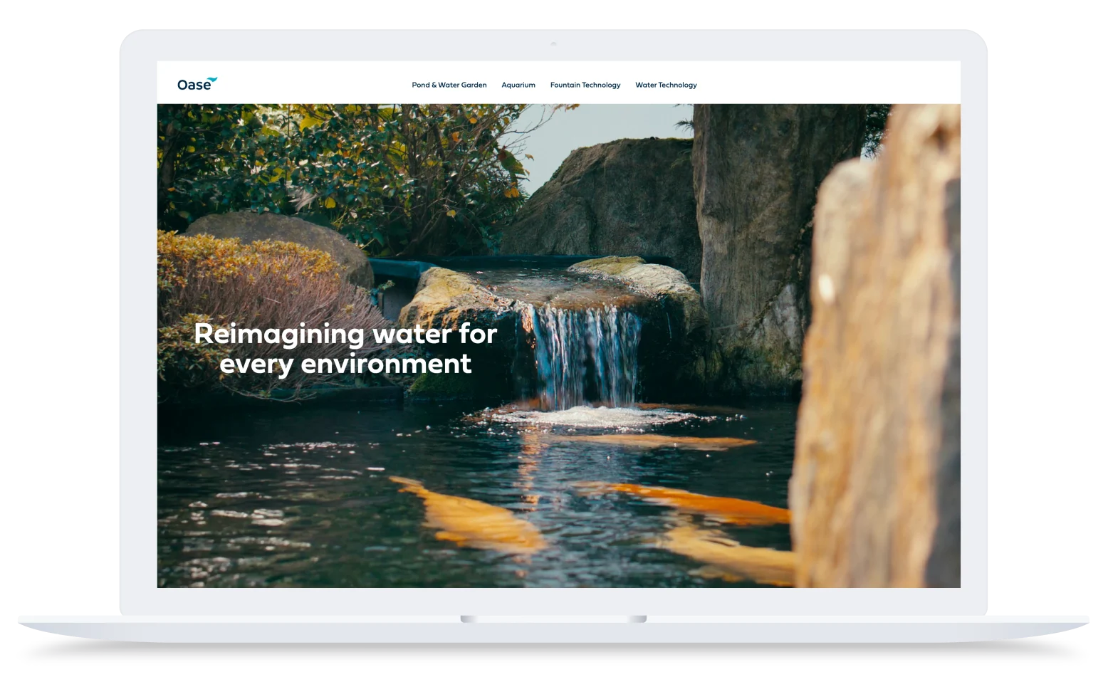 Oase website homepage showing koi pond with waterfall, rocks, and plants with text "Reimagining water for every environment"