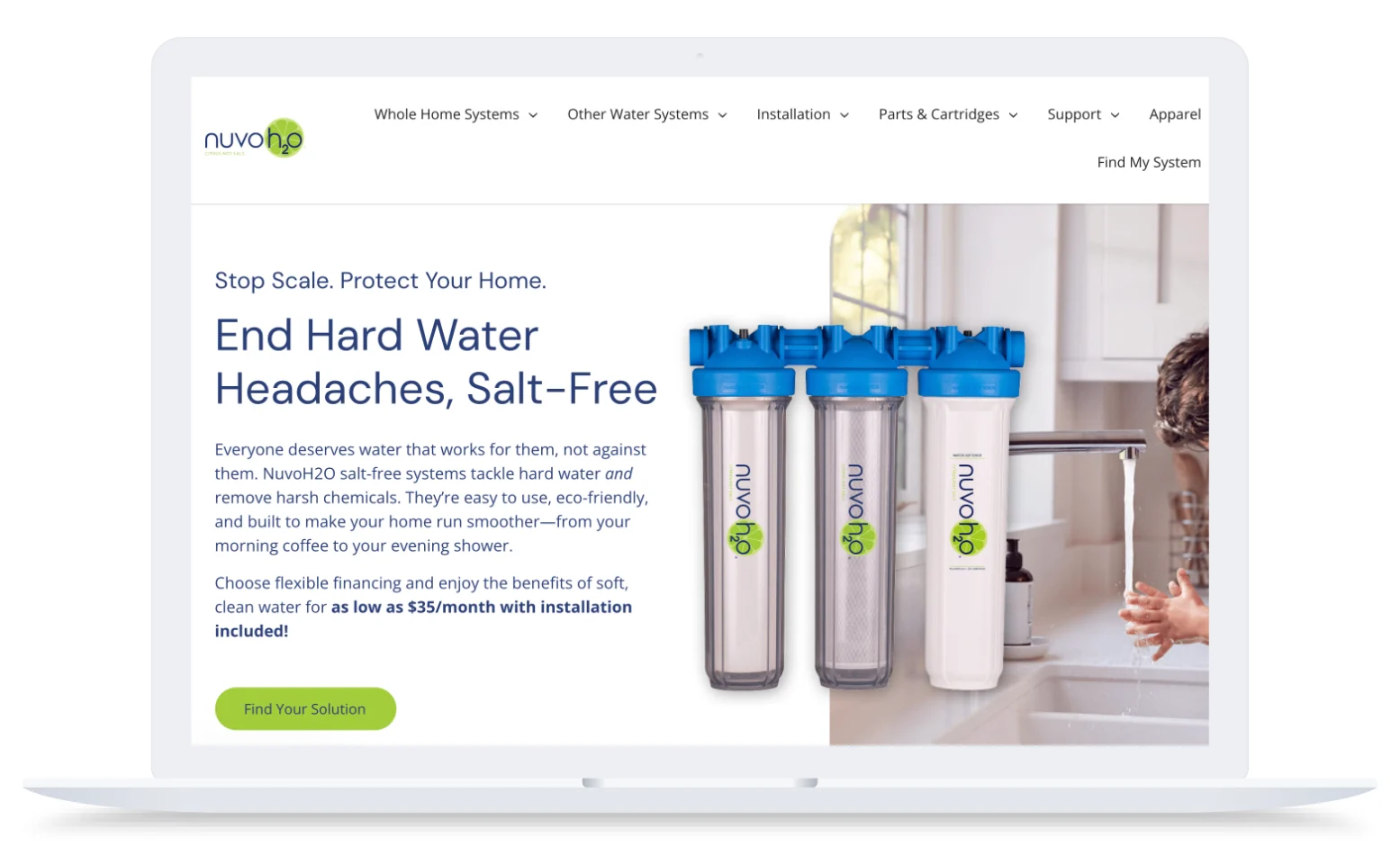 Laptop screen showing NuvoH2O water filters, a child washing hands at a sink, and text about salt-free water systems.