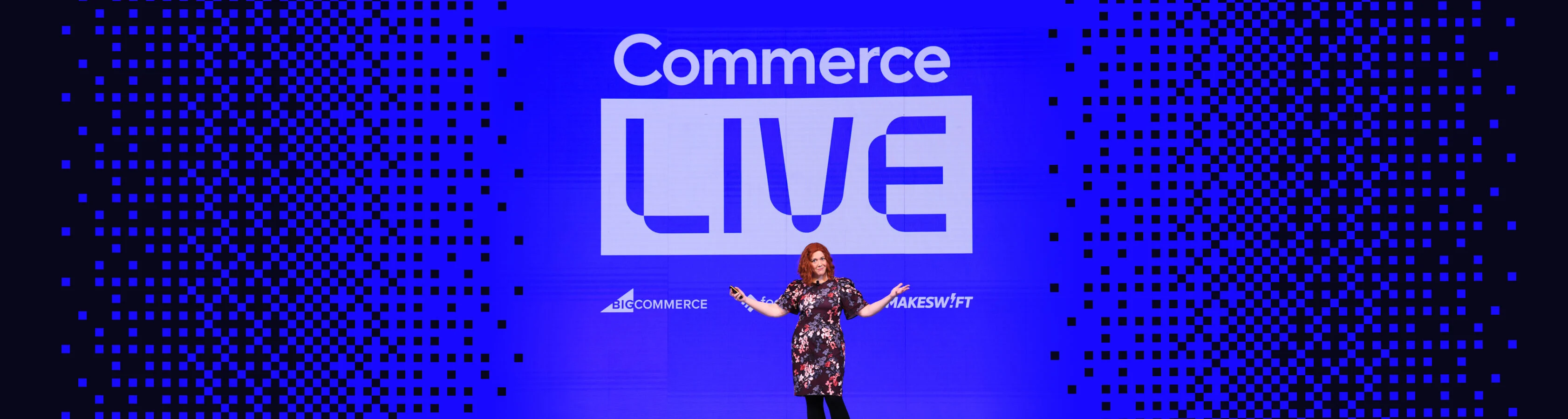 A woman with red hair and floral dress presenting on stage at Commerce 2026.