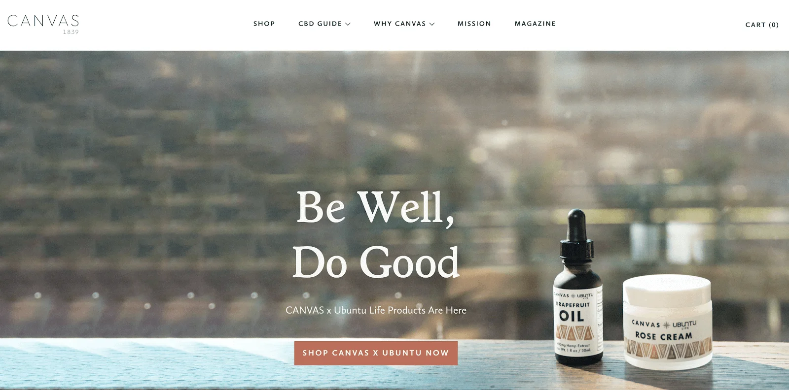 A bottle of grapefruit oil and a jar of rose cream on a wooden table with soft natural light and text reading Be Well, Do Good.