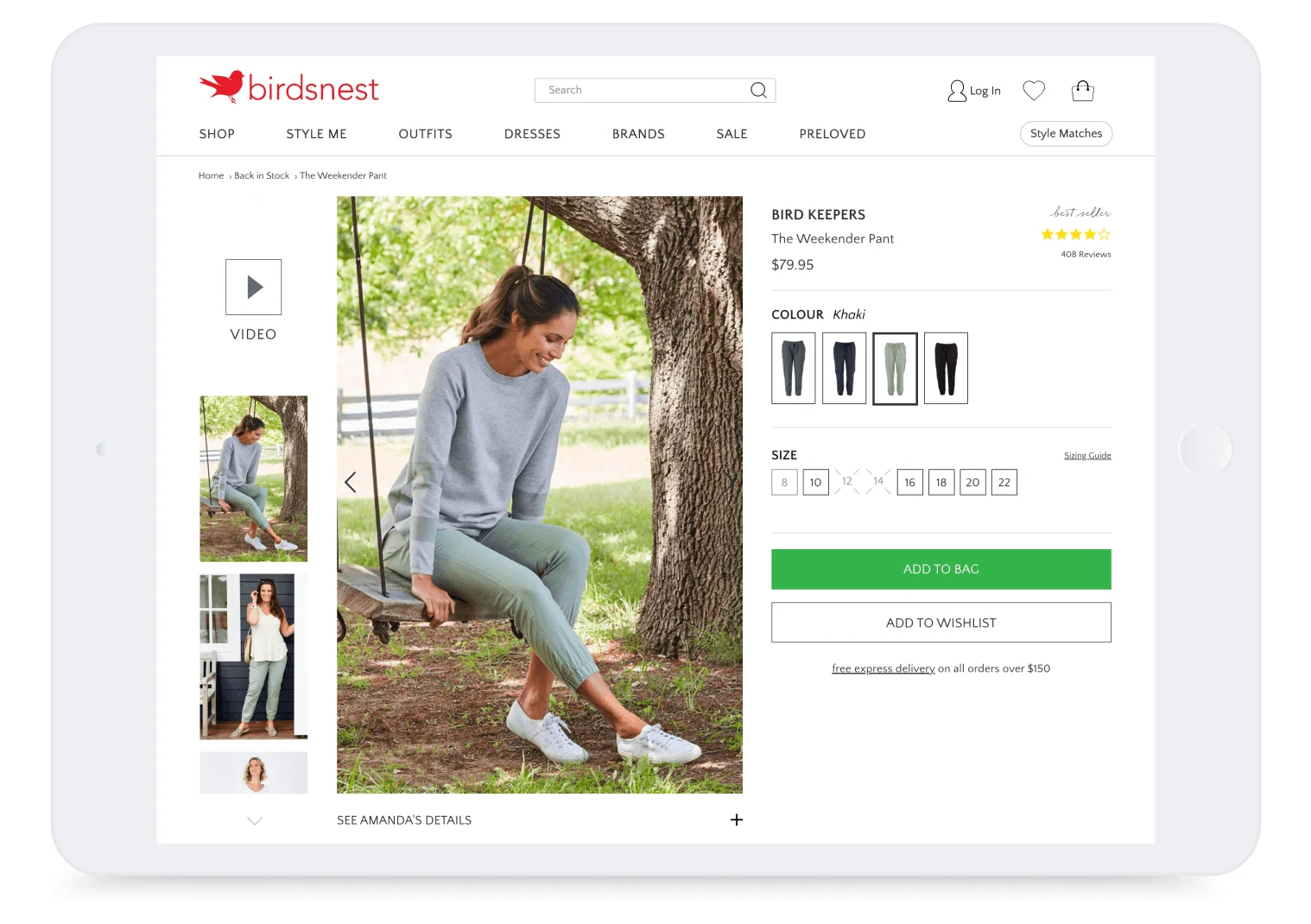 Woman in a grey sweater and khaki pants sits on a tree swing outdoors, smiling, with green grass and trees in background.