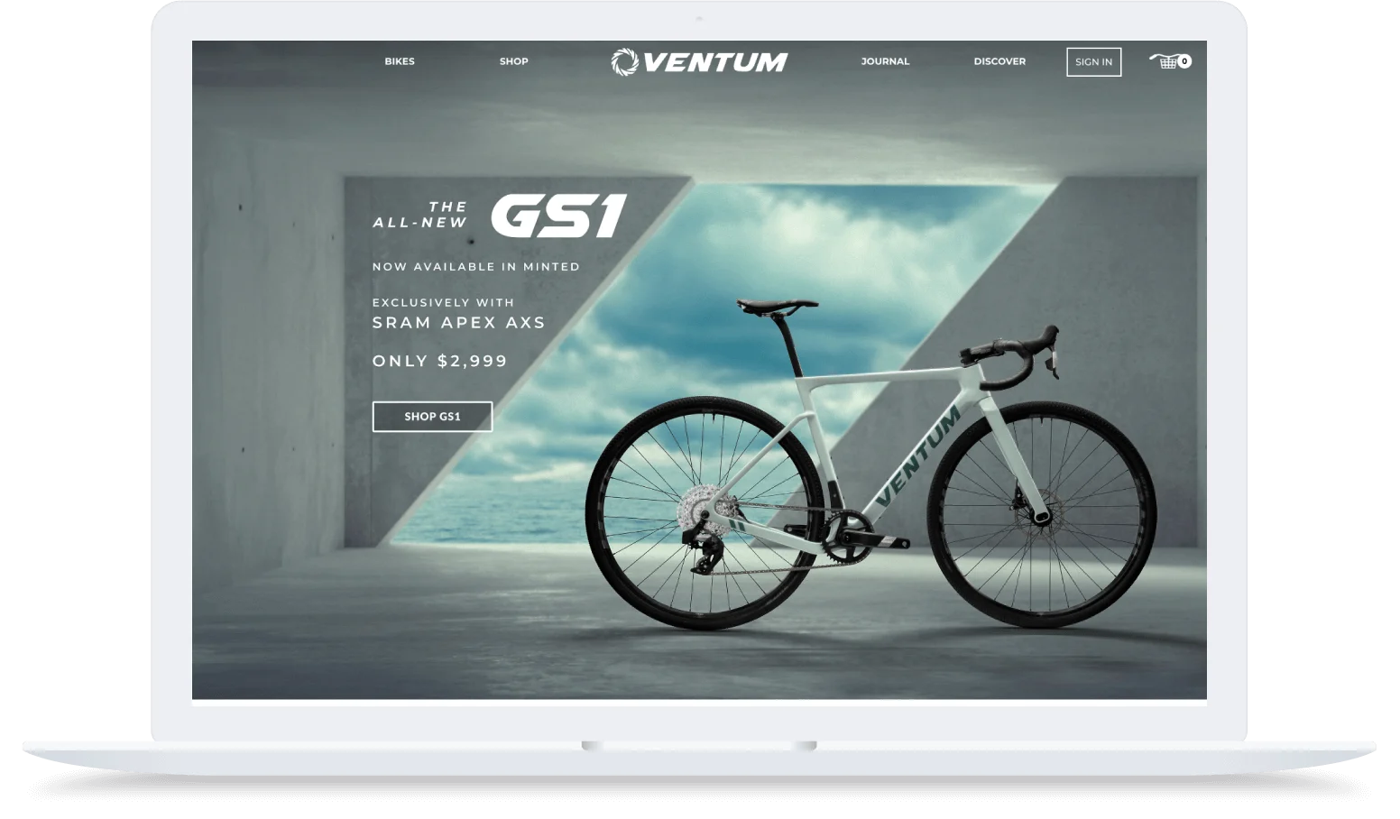A white Ventum GS1 bike is displayed indoors with modern concrete walls and a blue sky background on a laptop screen.