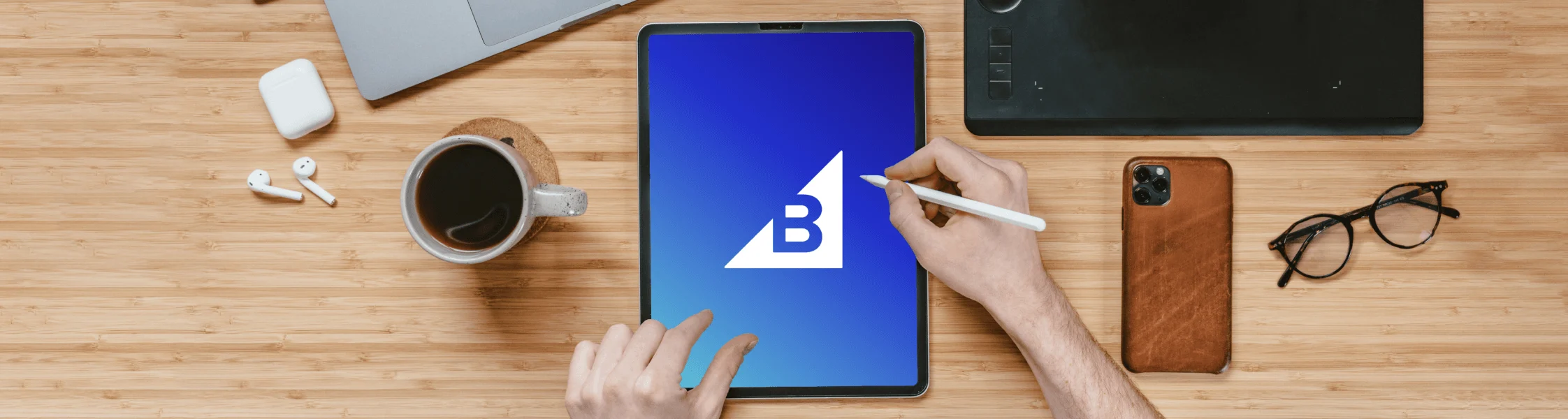 Article Header Tablet with BigCommerce Logo on a Desk