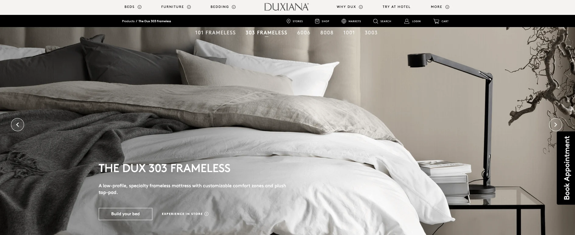 DUXIANA bedroom showcasing The DUX 303 Frameless mattress with luxurious layers of bedding and a modern black lamp.