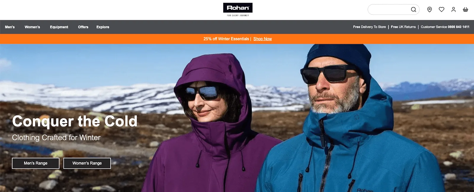 Man and woman in winter jackets and sunglasses outdoors with snowy mountains in the background under clear blue sky.