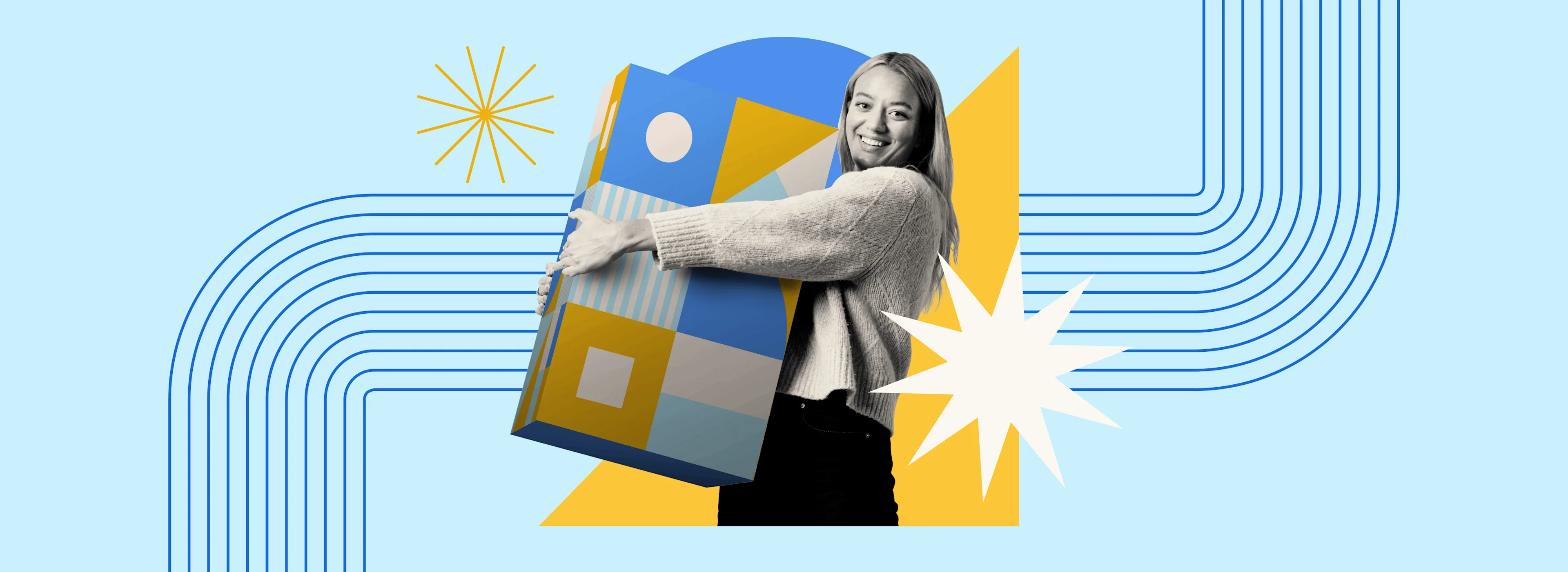 Smiling woman holding a large, colorful geometric box on a blue background with yellow and white abstract shapes and lines.