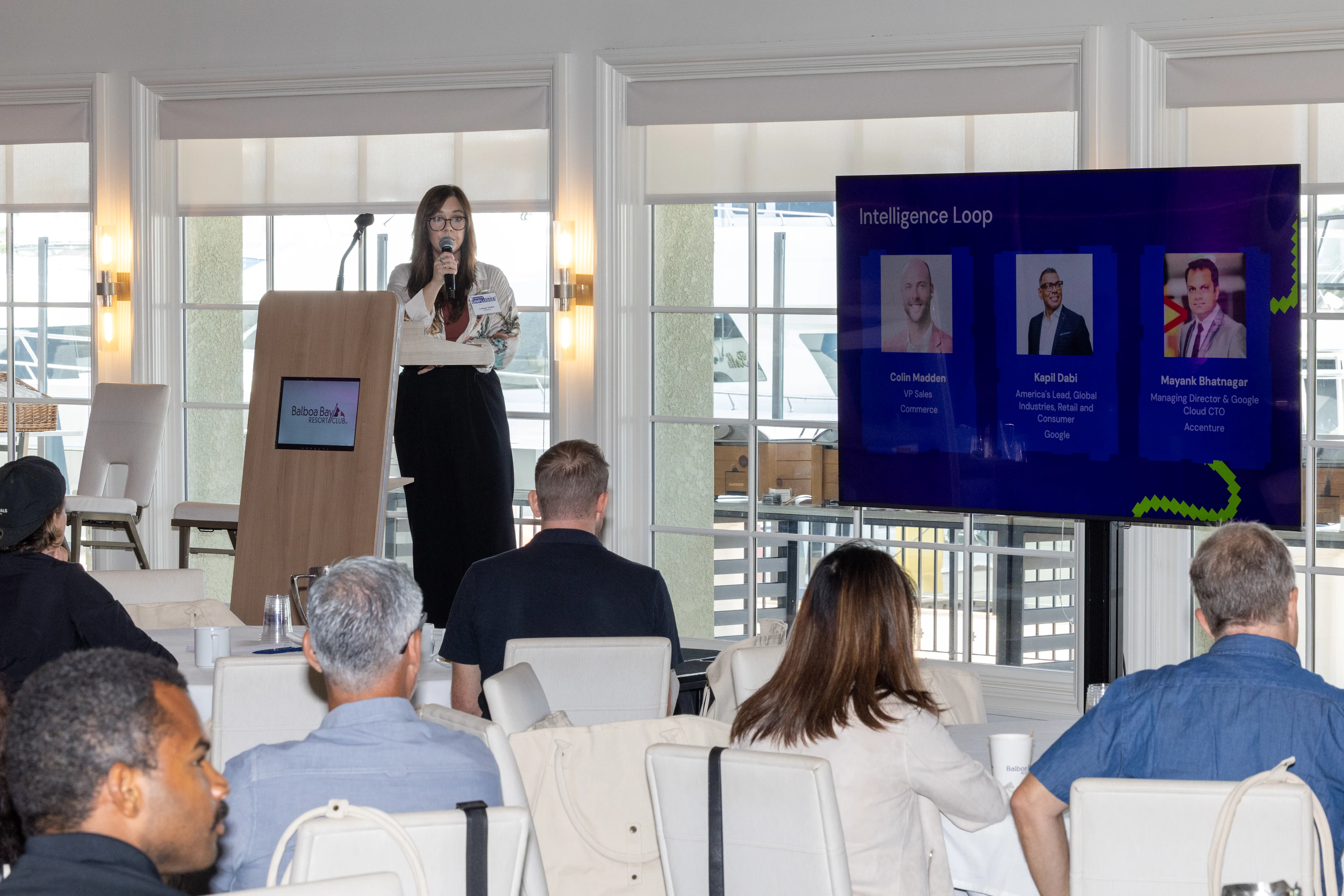 Lindsay Trinkle presenting in front of a crowd at Commerce Unplugged Newport Beach