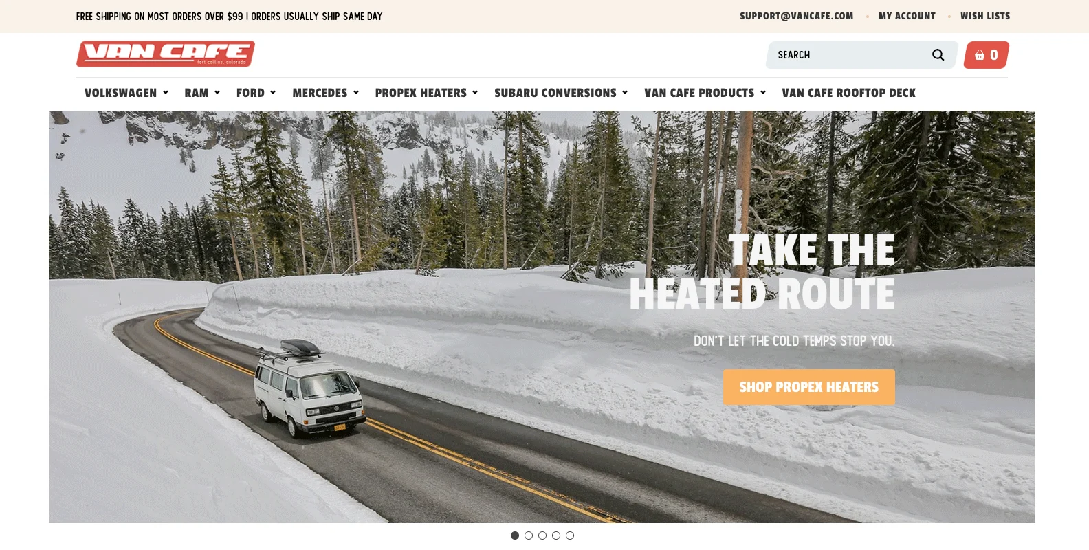 White van driving on a snow-lined mountain road with pine trees and snowy hills in the background under a cloudy sky.