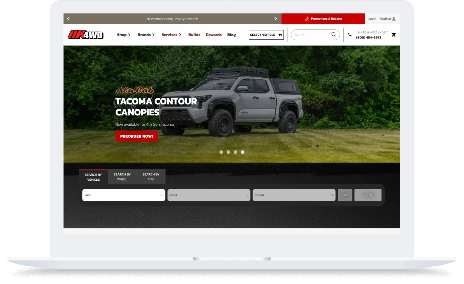 A gray Tacoma truck with a canopy is parked on grass in front of trees, featured on an OK4WD website preorder page.