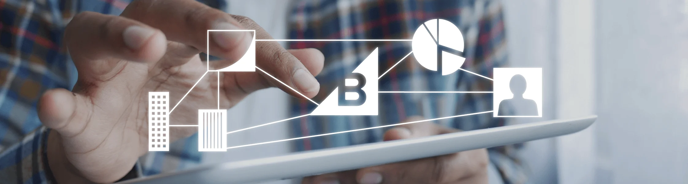 Person using a tablet displaying a conceptual network diagram connecting buildings, a user profile, a pie chart, and the letter B.