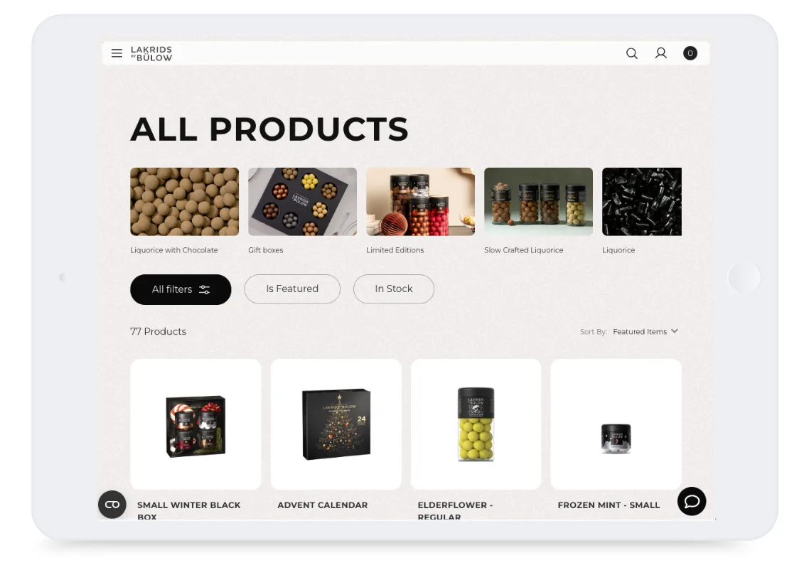 Tablet screen showing a webshop product page with assorted liquorice products, filters, and product images.