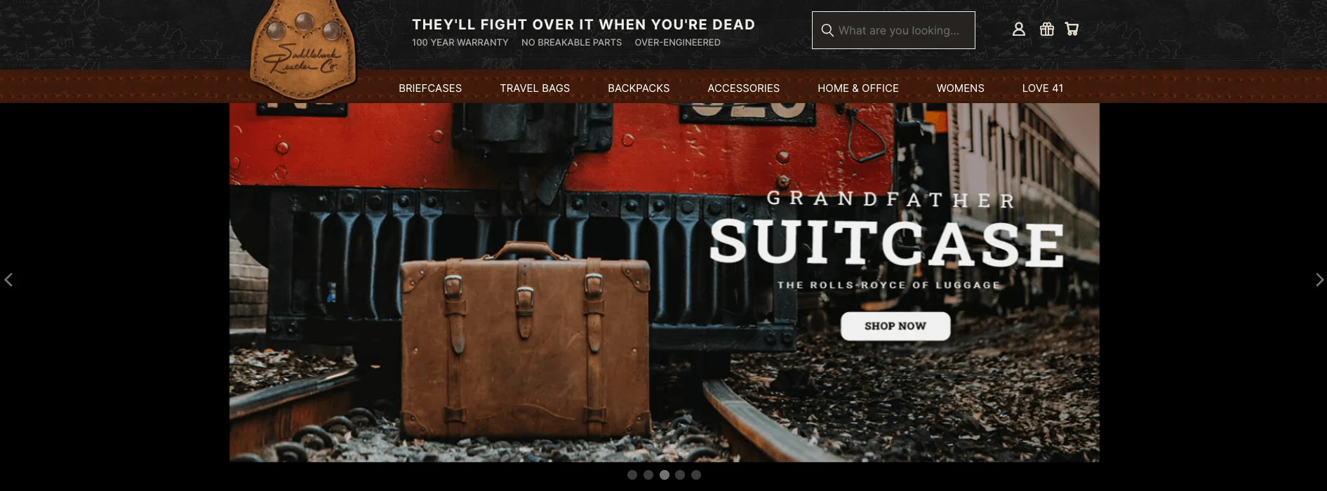 Brown leather suitcase on train tracks in front of a red train, with vintage travel and adventure theme.