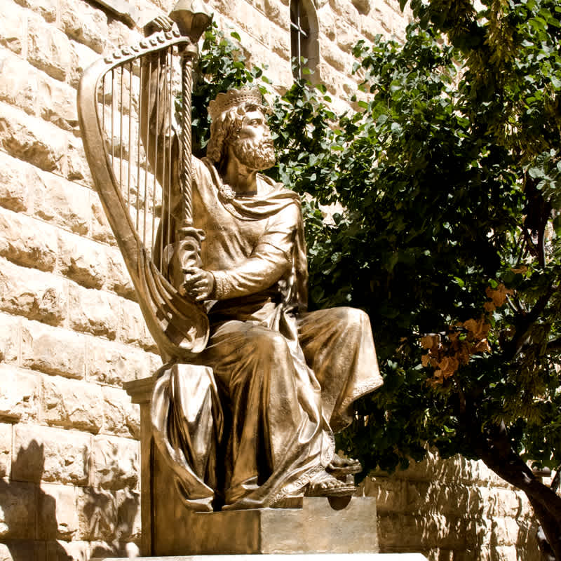 Golden statue of King David playing a harp in Jerusalem, Israel