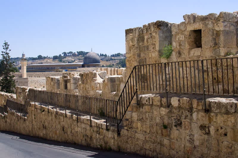 Fence along old buildings on the side of the road in Jerusalem, Israel