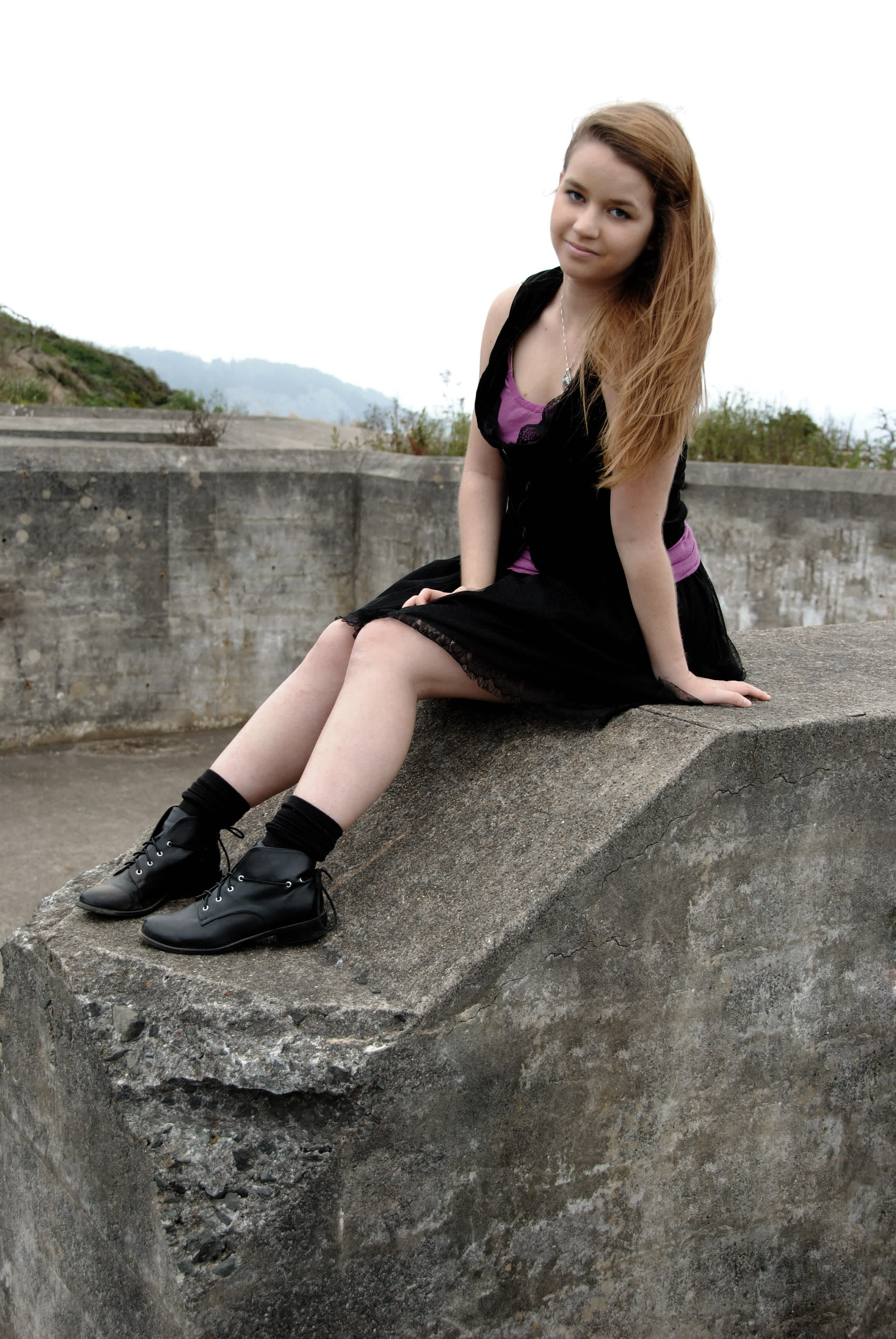 Girl sitting on a wall. 