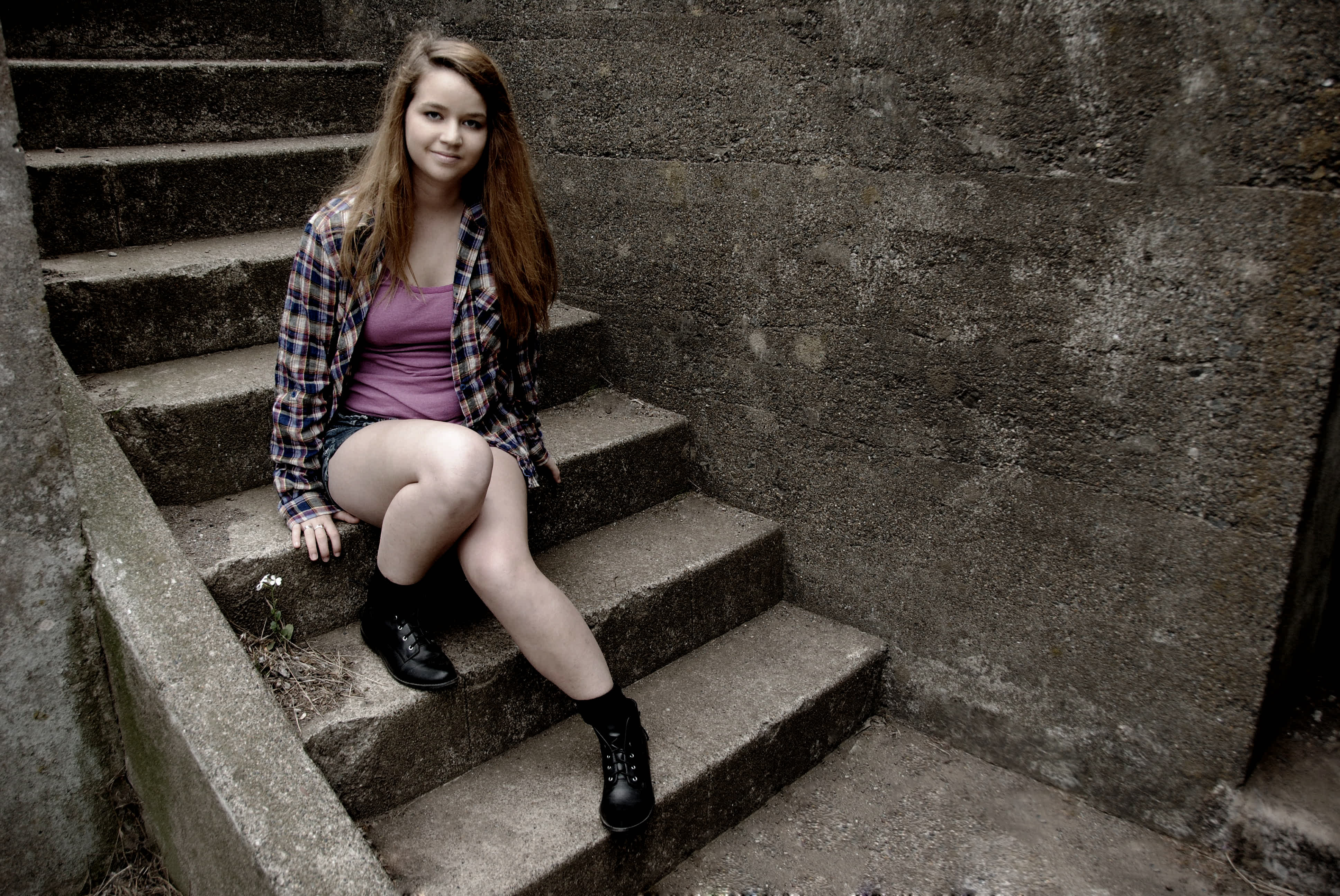 Girl sitting on a stairwell.