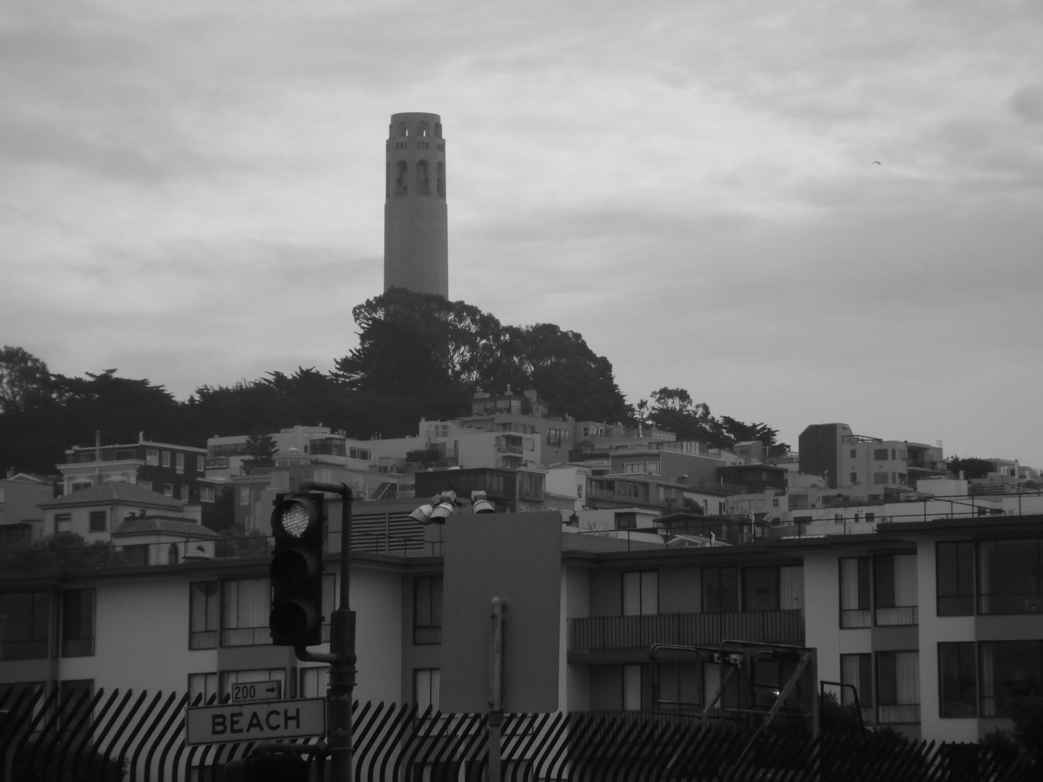 Buildings with a tall tower in the background in black and white in Embarcadero, San Francisco, California.