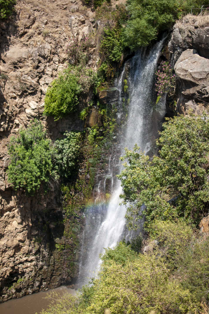 Waterfall with rainbow in Jilabun Stream, Golan Heights, Israel.