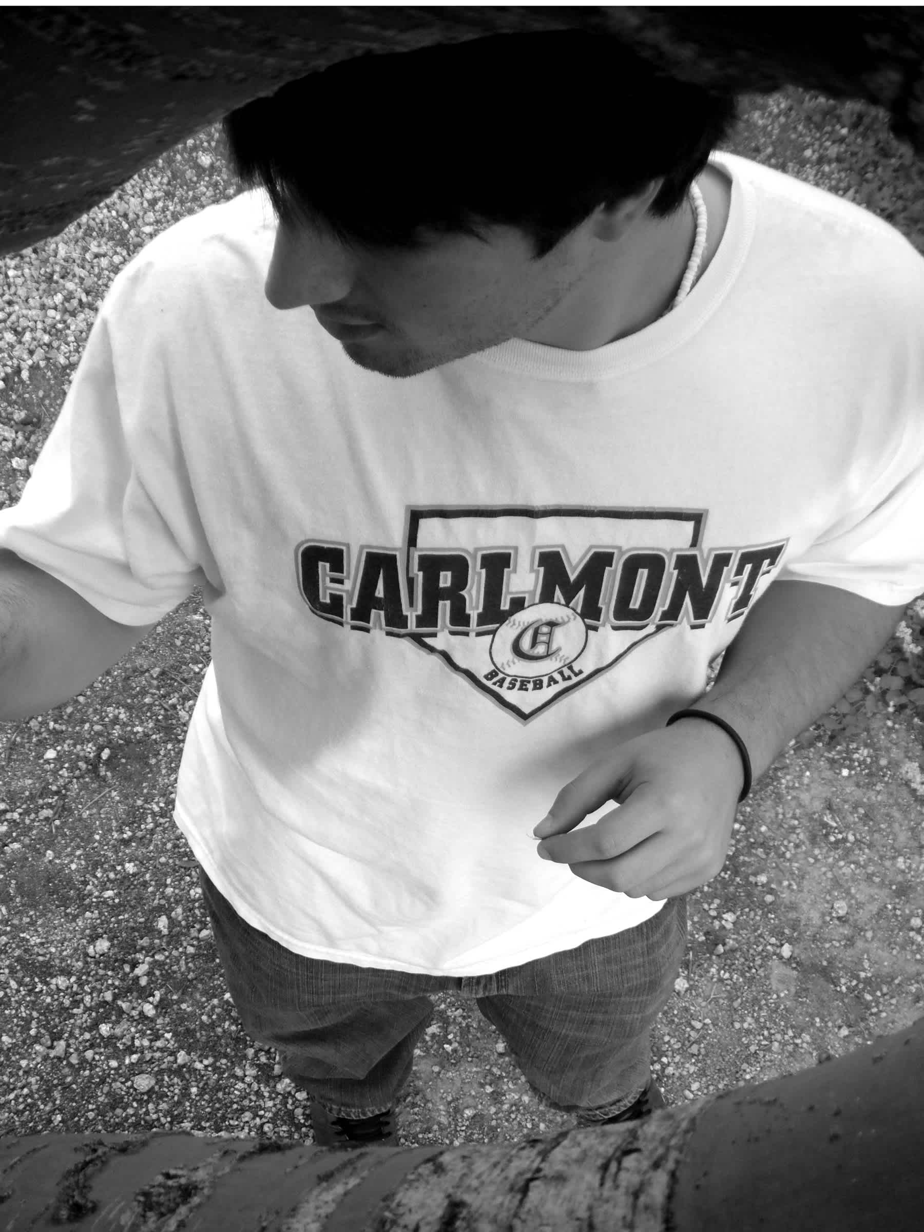 Black and white boy in Carlmont t-shirt looking to the side. 