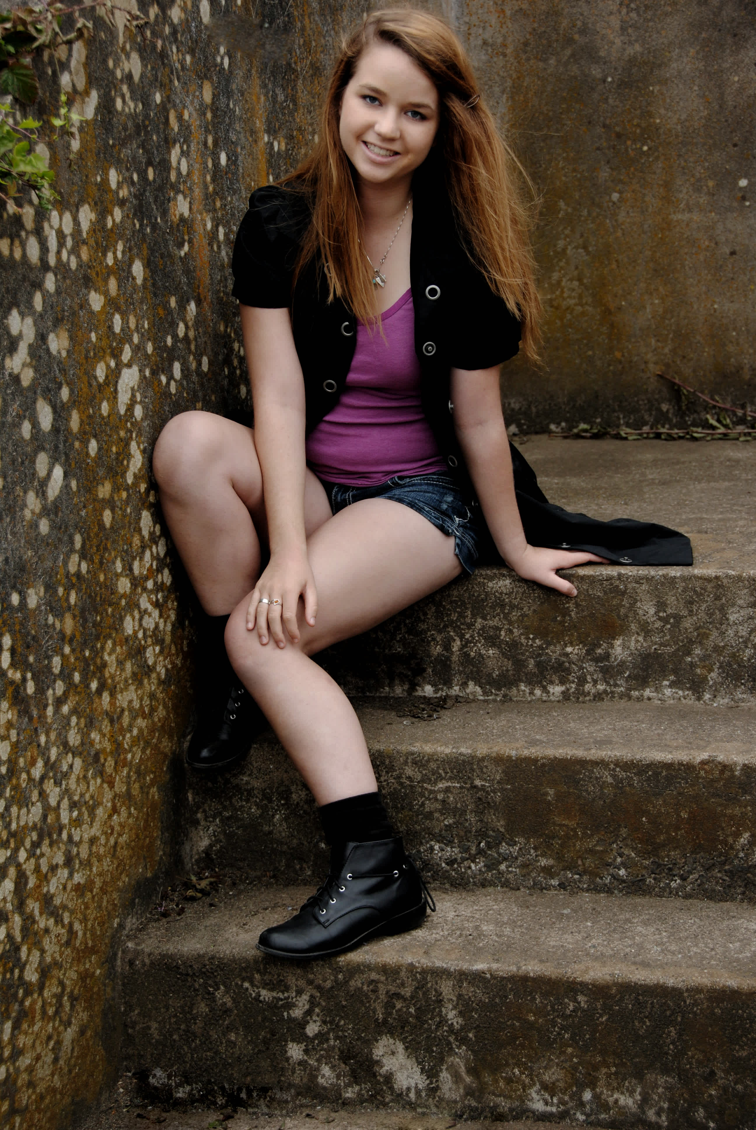 Girl sitting on a stairwell. 