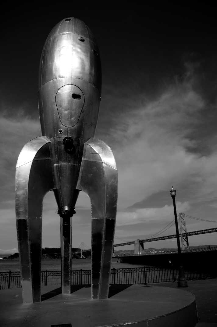 Metal statue shaped like a rocket ship in black and white in Ferry Building, San Francisco, California. 