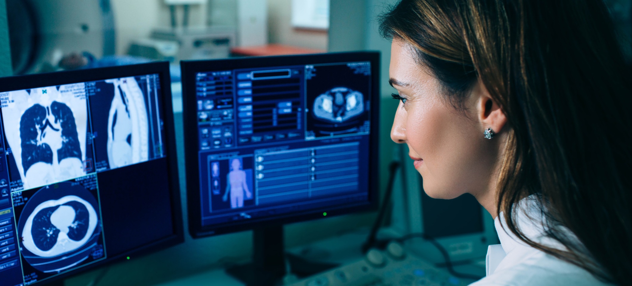 [Featured Image] A doctor benefits from explainable AI as they read the AI diagnosis on two computer screens displaying images of internal organs and data.
