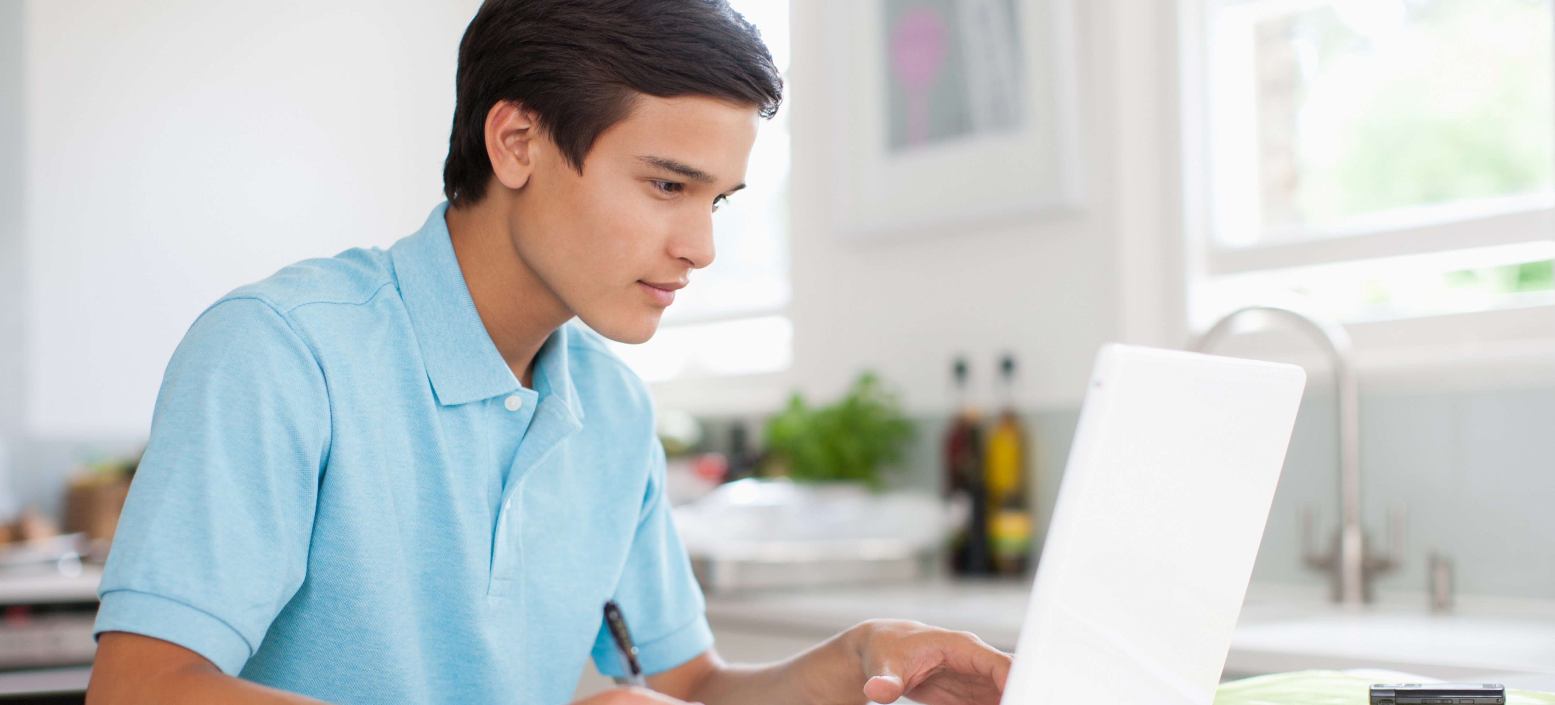 [Feature Image] A learner works with synthetic data sets on their laptop as part of their coursework. 
