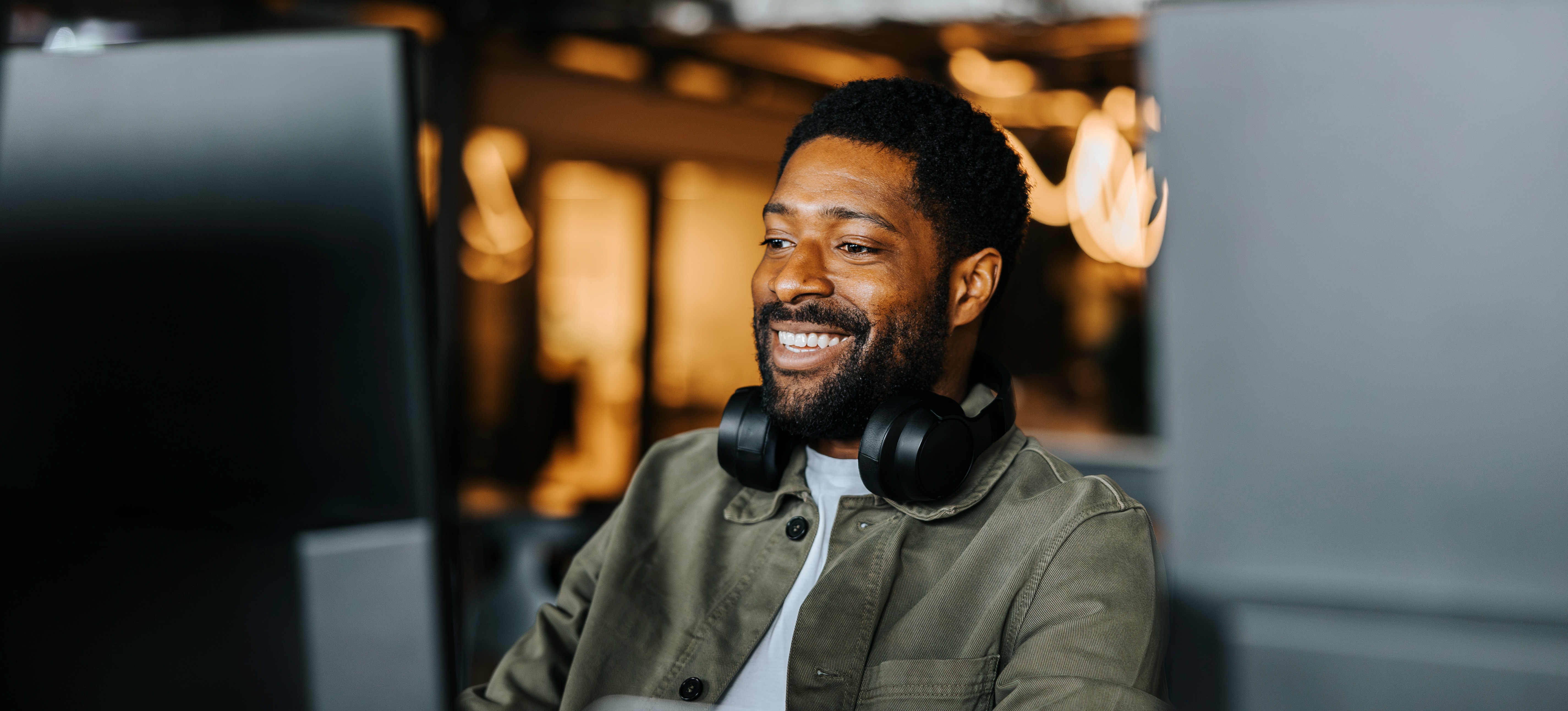 [Featured Image]: An IT professional works at a computer after learning how to get IT certifications to qualify for a new job.
