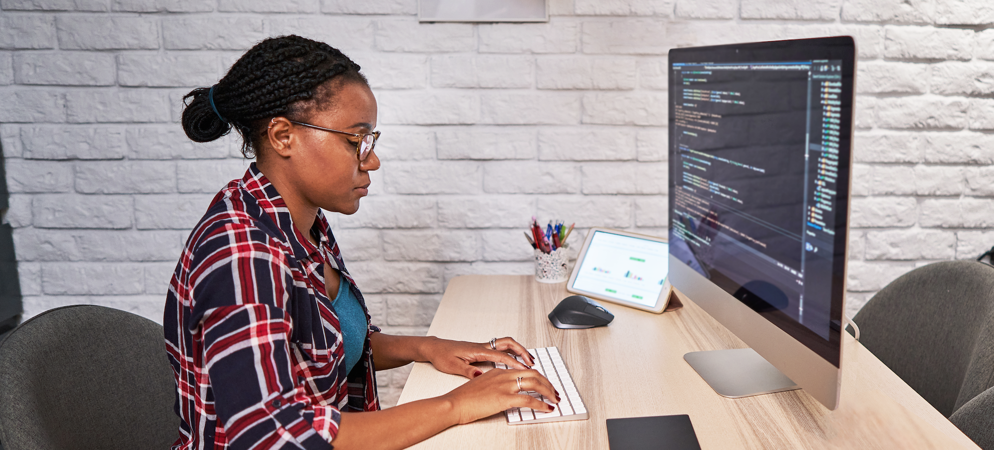 [Featured image] A JavaScript developer writes code at their computer.