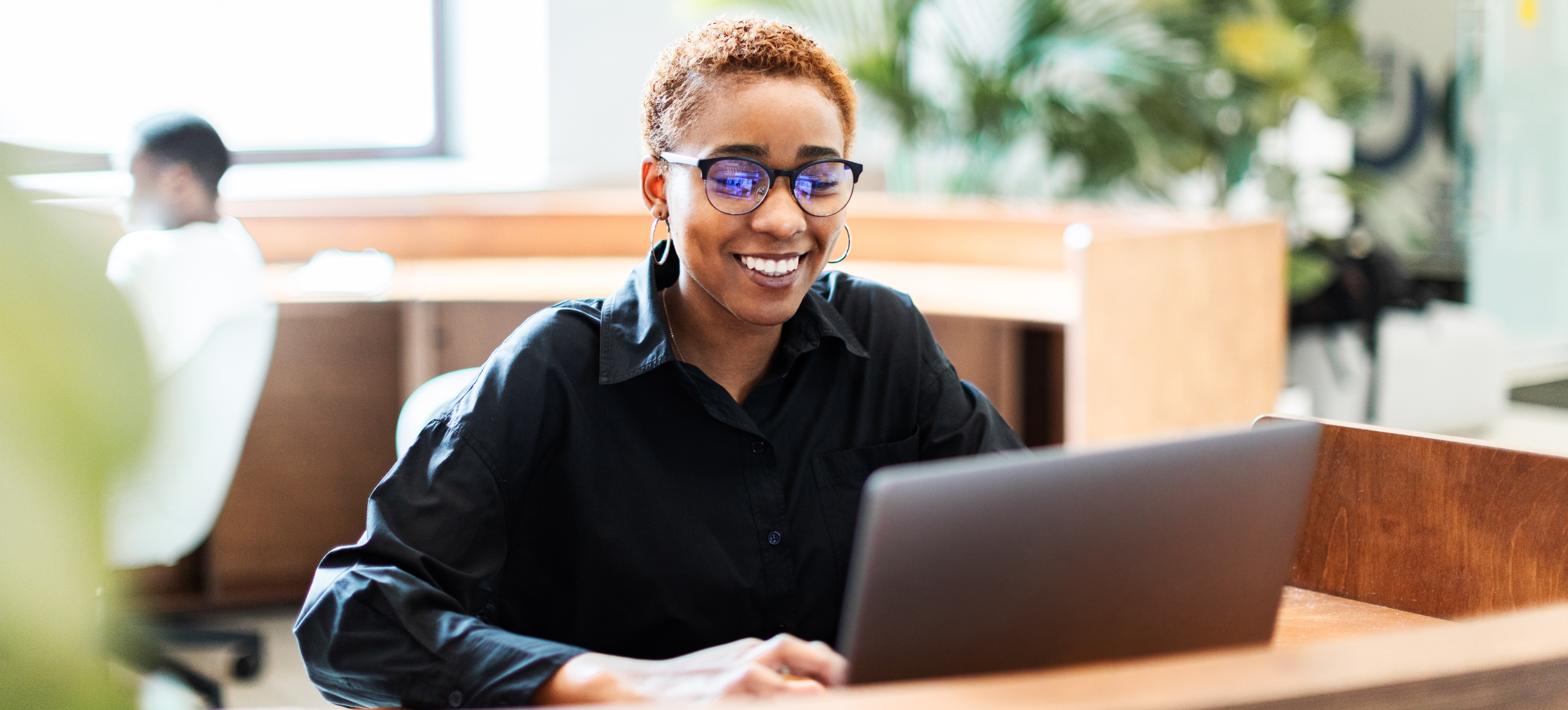 [Feature Image] A learner researches LoRaWAN vs. NB IoT on their laptop while in a shared study space as part of their coursework covering network protocols.
